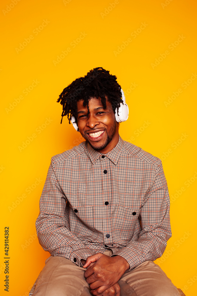young handsome african american guy student posing cheerful and gesturing on yellow background, lifestyle people concept young handsome african american guy student posing cheerful and gesturing on yellow background, lifestyle people concept