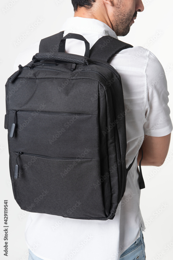 Man with black laptop backpack rear view studio shoot Man with black laptop backpack rear view studio shoot