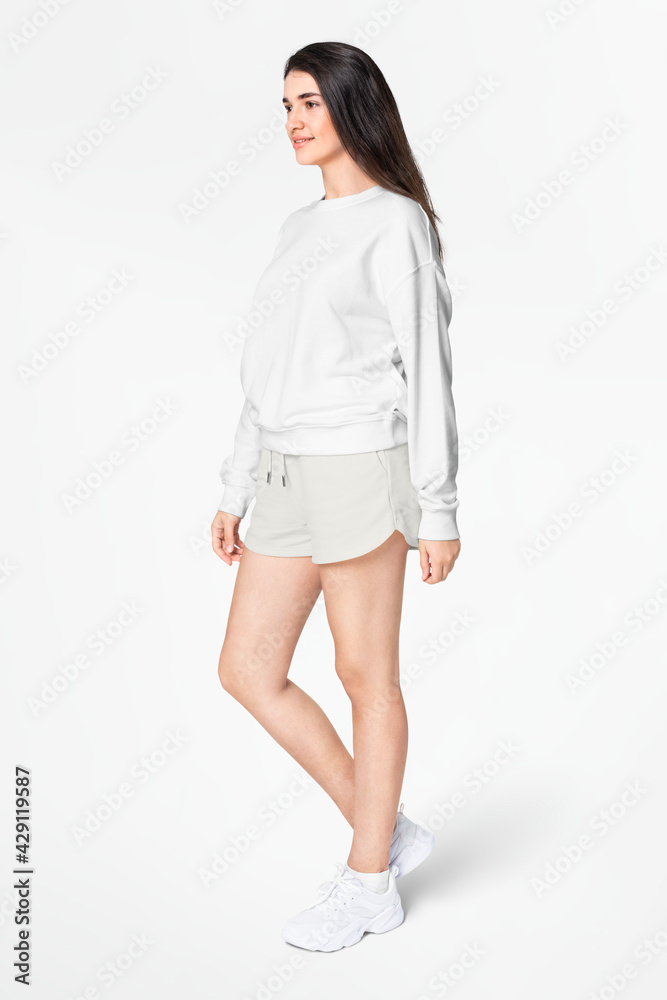 Woman in green sweater and shorts casual apparel Woman in green sweater and shorts casual apparel