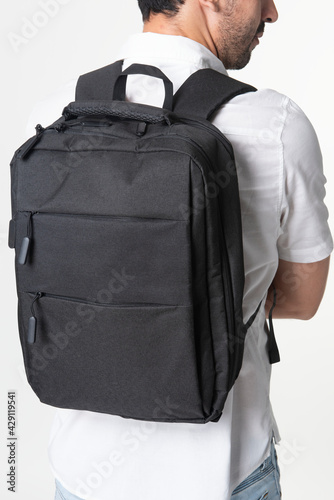 Man with black laptop backpack rear view studio shoot
