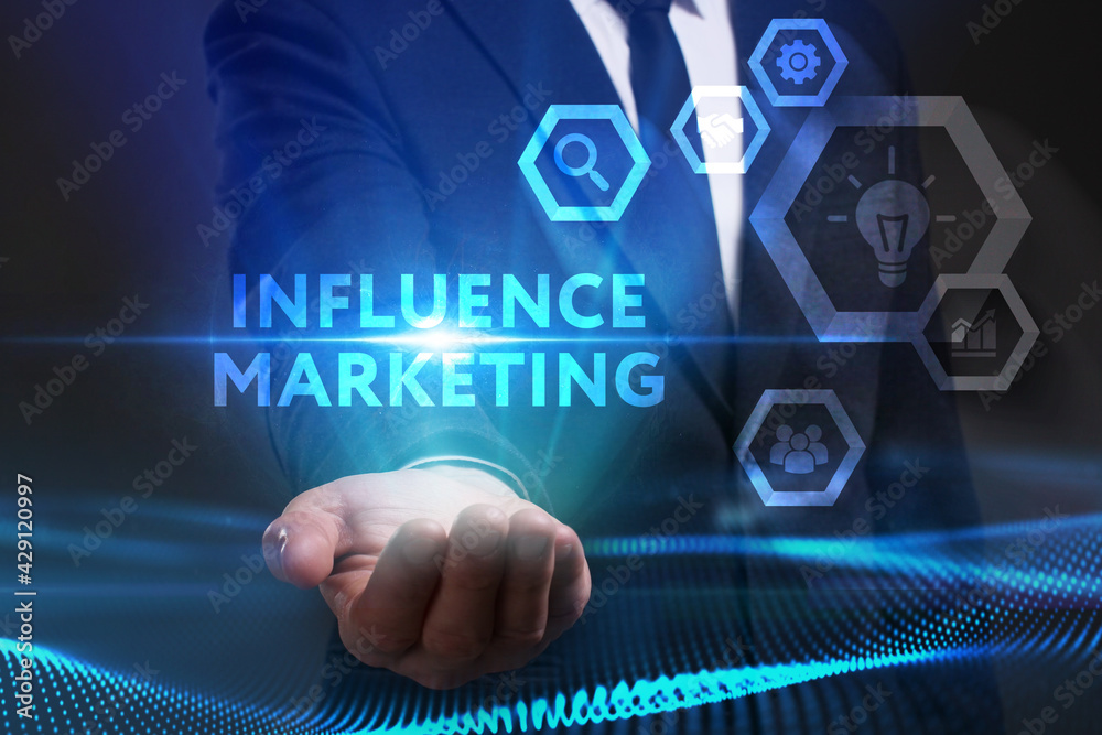 Business, Technology, Internet and network concept. Young businessman working on a virtual screen of the future and sees the inscription: Influence marketing Business, Technology, Internet and network concept. Young businessman working on a virtual screen of the future and sees the inscription: Influence marketing