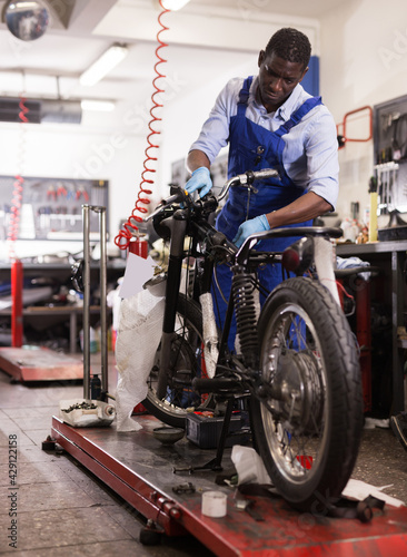 Service engineer repairing motorcycle in motorcycle service. High quality photo