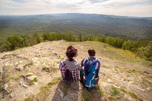 hikers men and women sit on top of mountain sugomak on summer sunny day photo