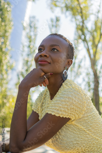 Portrait of an African American woman looking upwards, low angle view, vertical photo