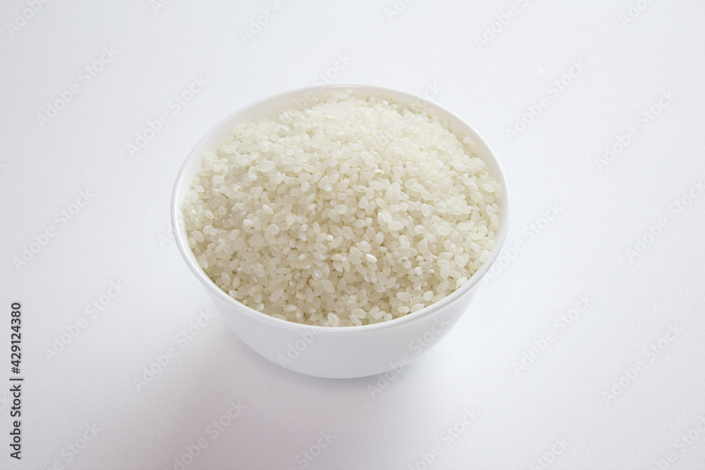 rice grains in a bowl isolated on white background. rice grains in a bowl isolated on white background.