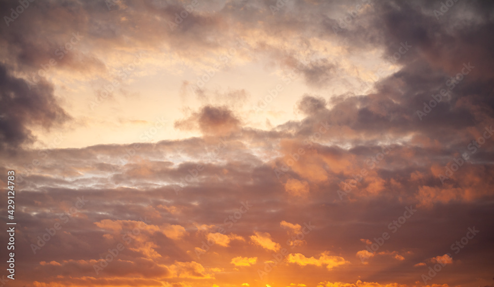 Dramatic sky with orange clouds over the city before dawn or sunset. Weather before or after a storm. Dramatic sky with orange clouds over the city before dawn or sunset. Weather before or after a storm.