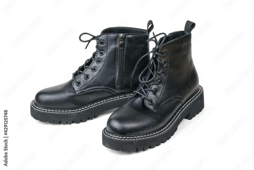 A pair of high leather boots with laces isolated on a white background.