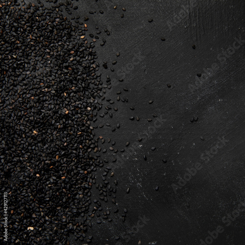 Black sesame seed on black background. Organic food concept.
