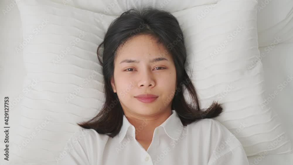 Beautiful Asian woman waking up in the morning in bed feeling happy. Beautiful Asian woman waking up in the morning in bed feeling happy.