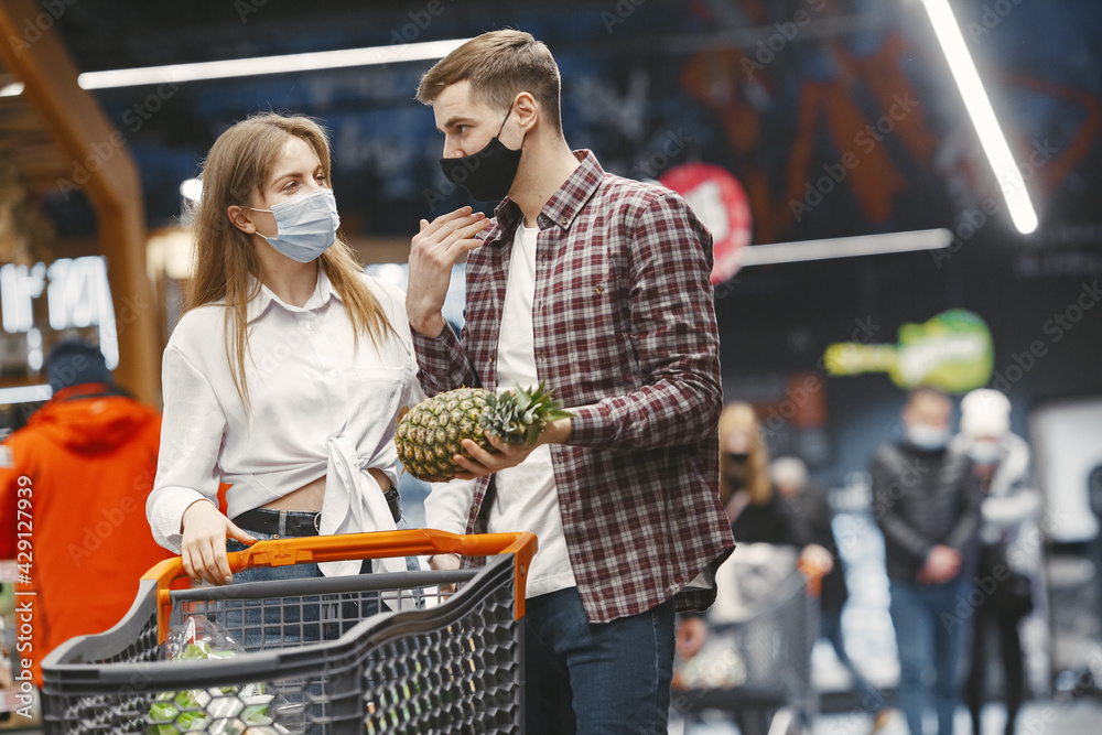 People in a medical mask in a supermarket