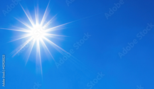 Shining sun over perfect blue sky background