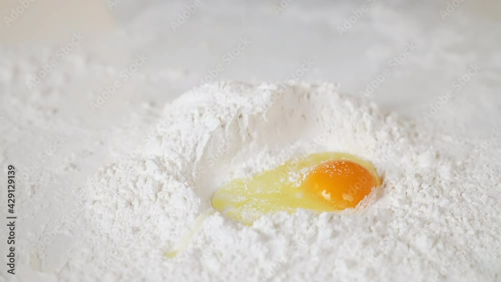 Egg drop on flour on the table with for making various desserts. Egg drop on flour on the table with for making various desserts.