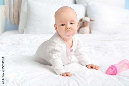 Cute little baby with bottl...