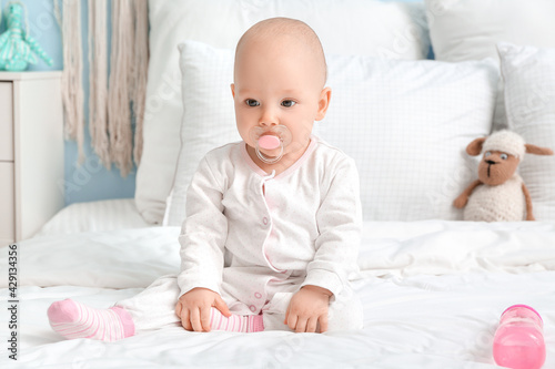 Cute little baby with bottl...