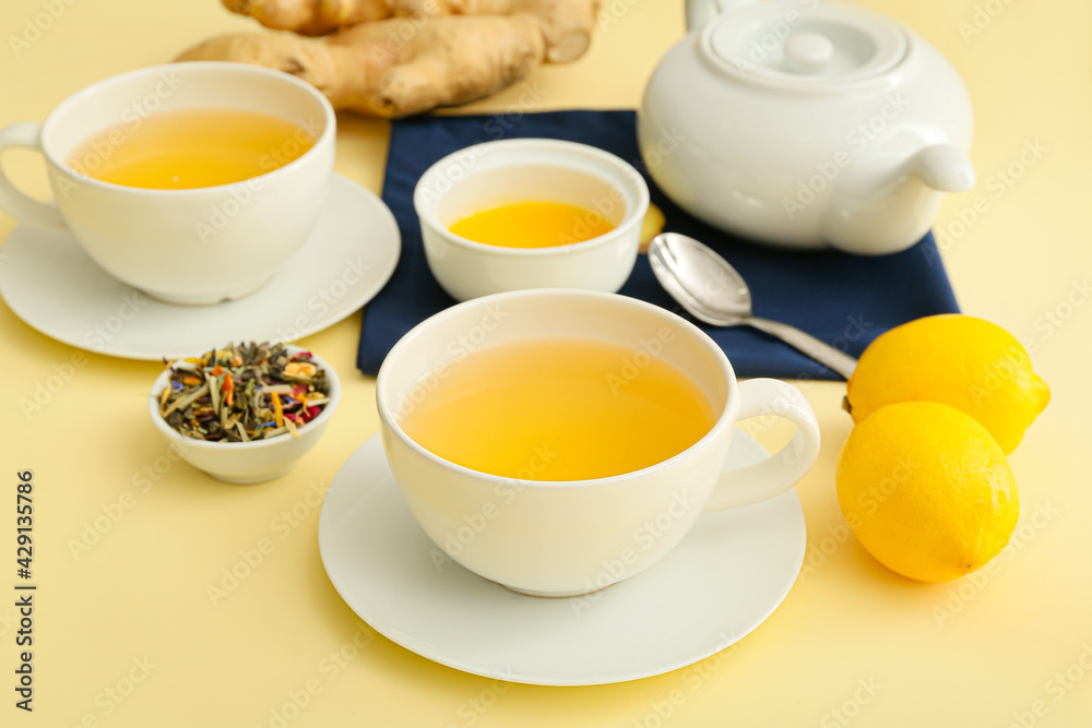 Teapot and cups of tea with ginger on color background Teapot and cups of tea with ginger on color background