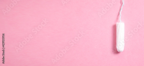 Menstrual tampon on a pink background.
