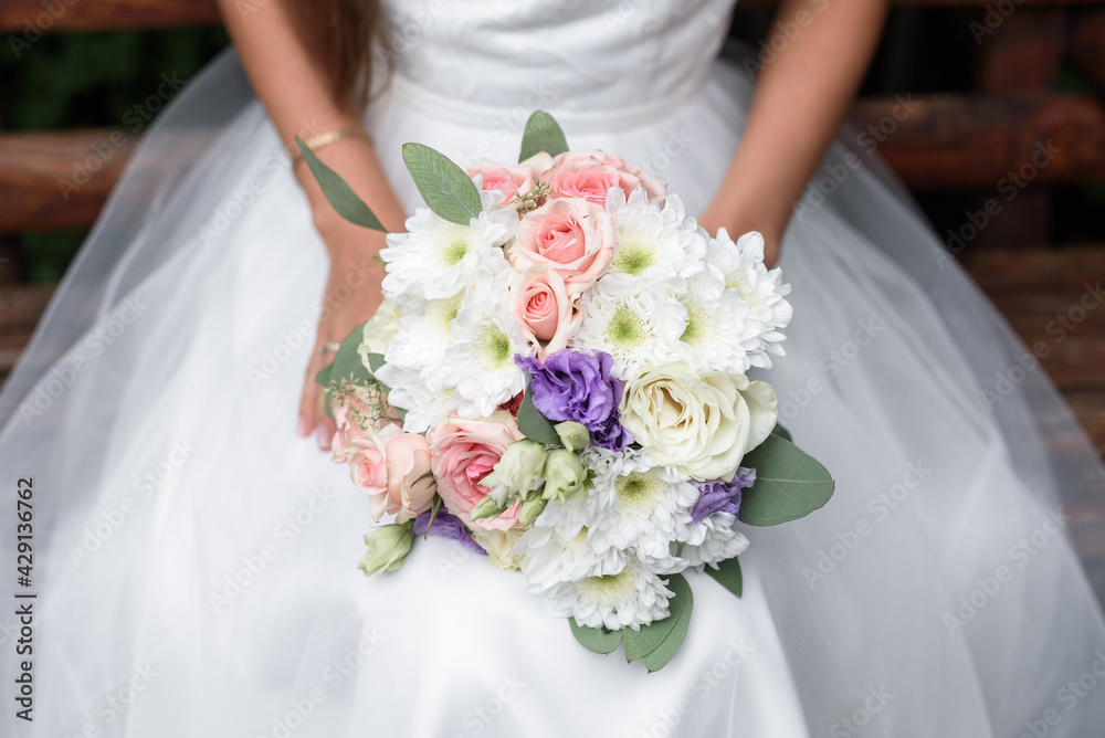 wedding bouquet in the hands of the bride wedding bouquet in the hands of the bride