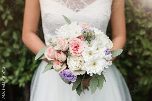 wedding bouquet in the hands of the bride
