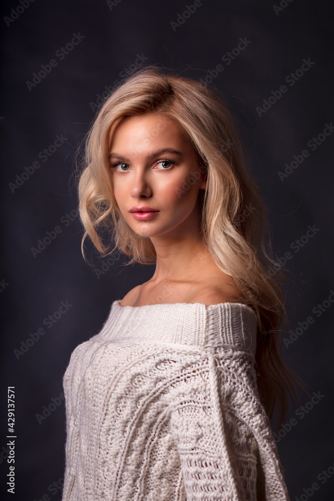 Blonde, studio portrait of a young girl