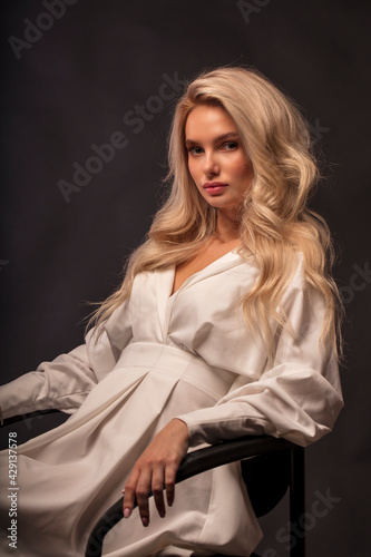 Blonde, studio portrait of a young girl