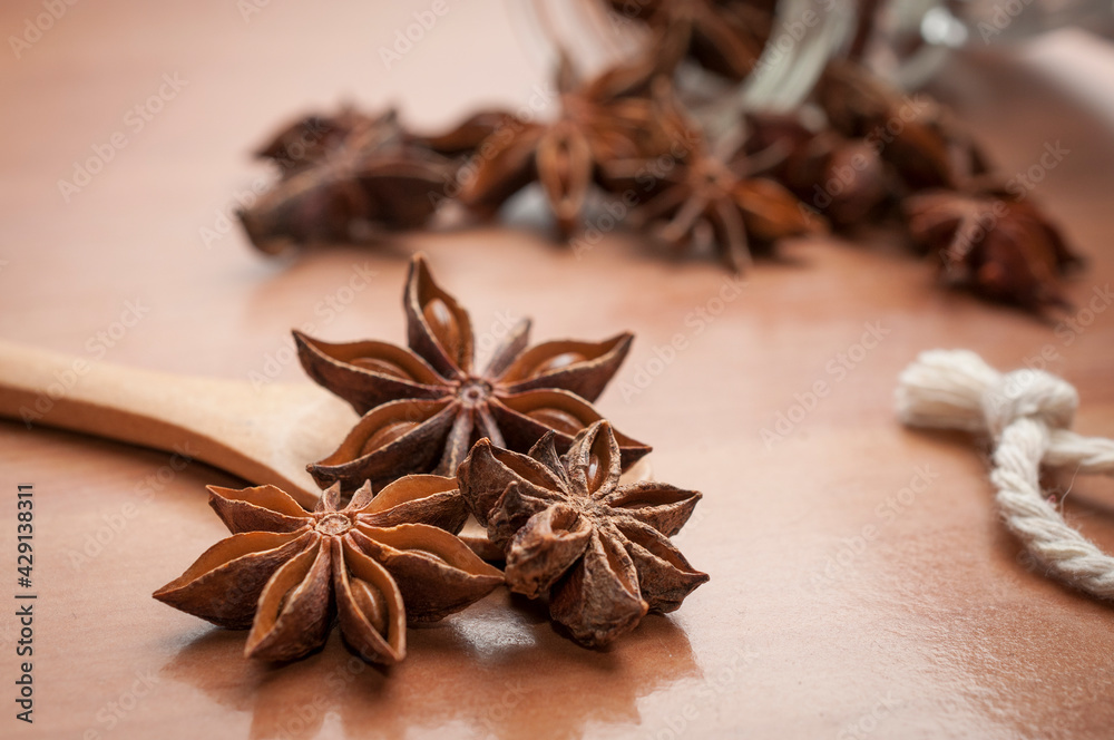 Some star anise seeds and fruits on wooden spoon Some star anise seeds and fruits on wooden spoon