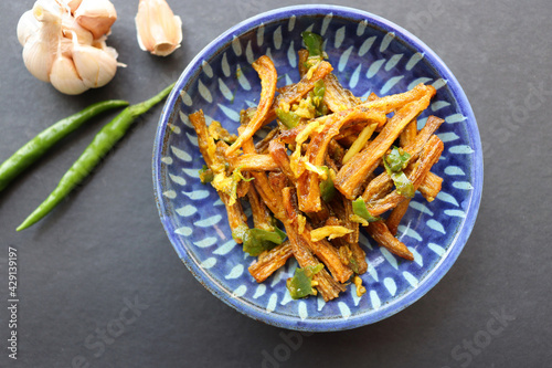 Dry Bombay duck fried with chili and garlic. Dried Bombay duck masala. also known as suke bombil masala in Marathi. Dried bombil chutney. Dehydrated bombil fish. Copy space. photo