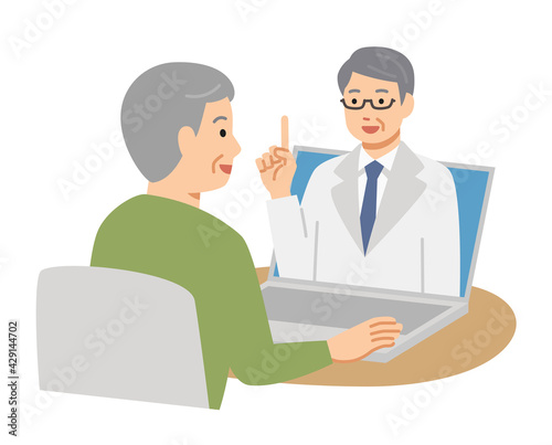 パソコンでオンライン診療を受ける笑顔のシニア男性
