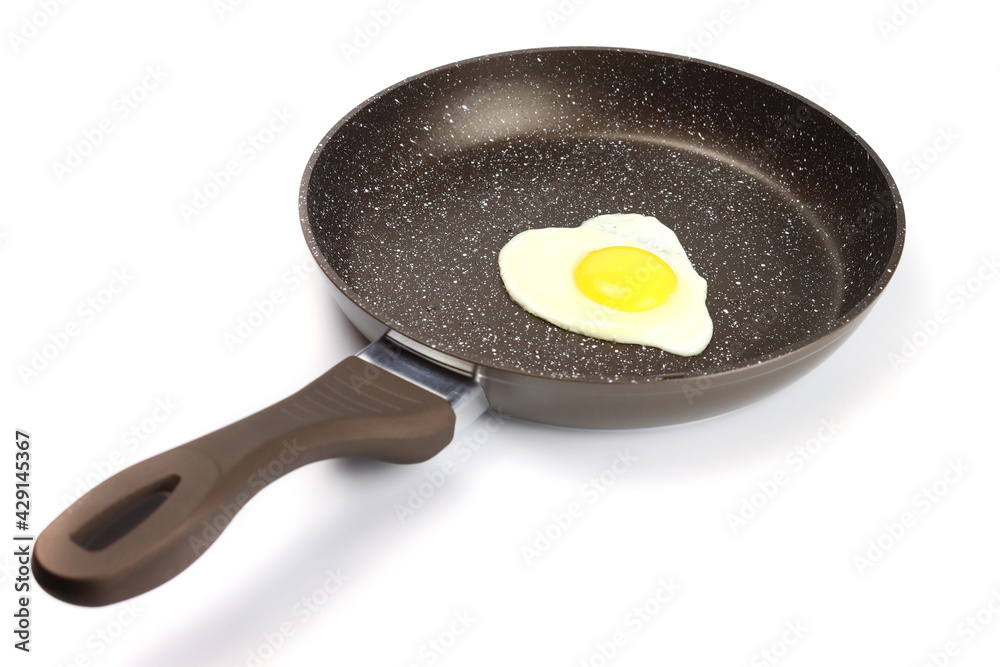fried egg in a non-stick frying pan isolated on white fried egg in a non-stick frying pan isolated on white