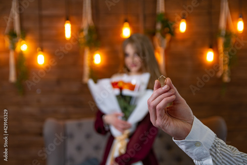 Proposal to marry, wedding ring in the hands of the groom.