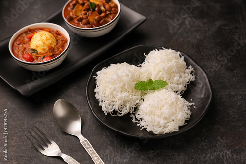 Canvas Print Noolappam/Idiyappam/rice noodles, a popular traditional steam cooked Kerala breakfast dish with hot and spicy egg roast curry on a houseboat, Alleppey, India