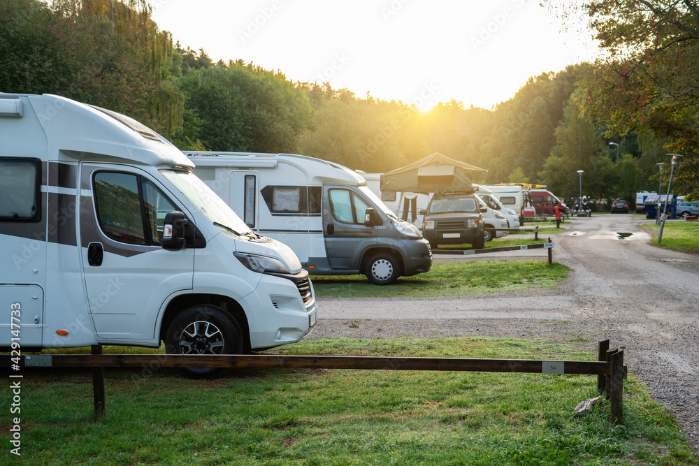 Camper vans in a camping park - obrazy, fototapety, plakaty 