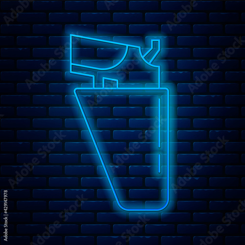 Glowing neon line Revolver gun in holster icon isolated on brick wall background. Vector