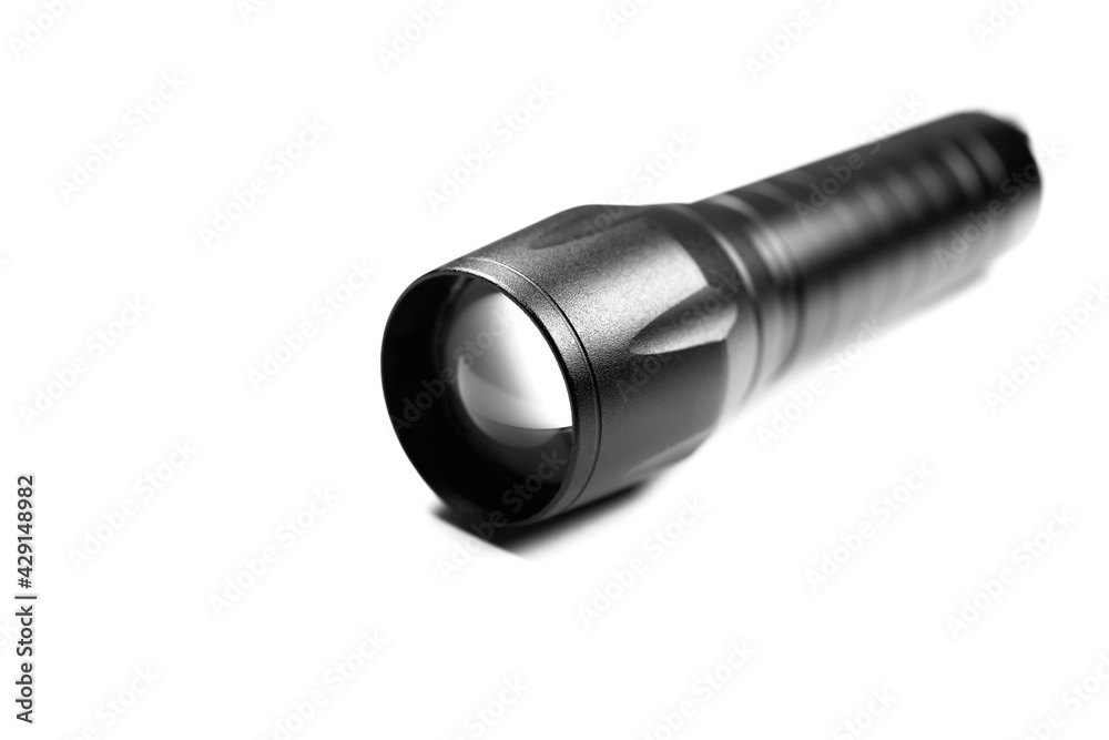 Black Flashlight on the white background. Close up. Black Flashlight on the white background. Close up.