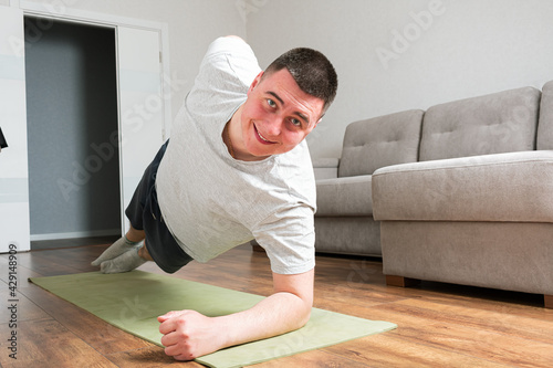 Sporty young man do exercises at home © Владислав Легір