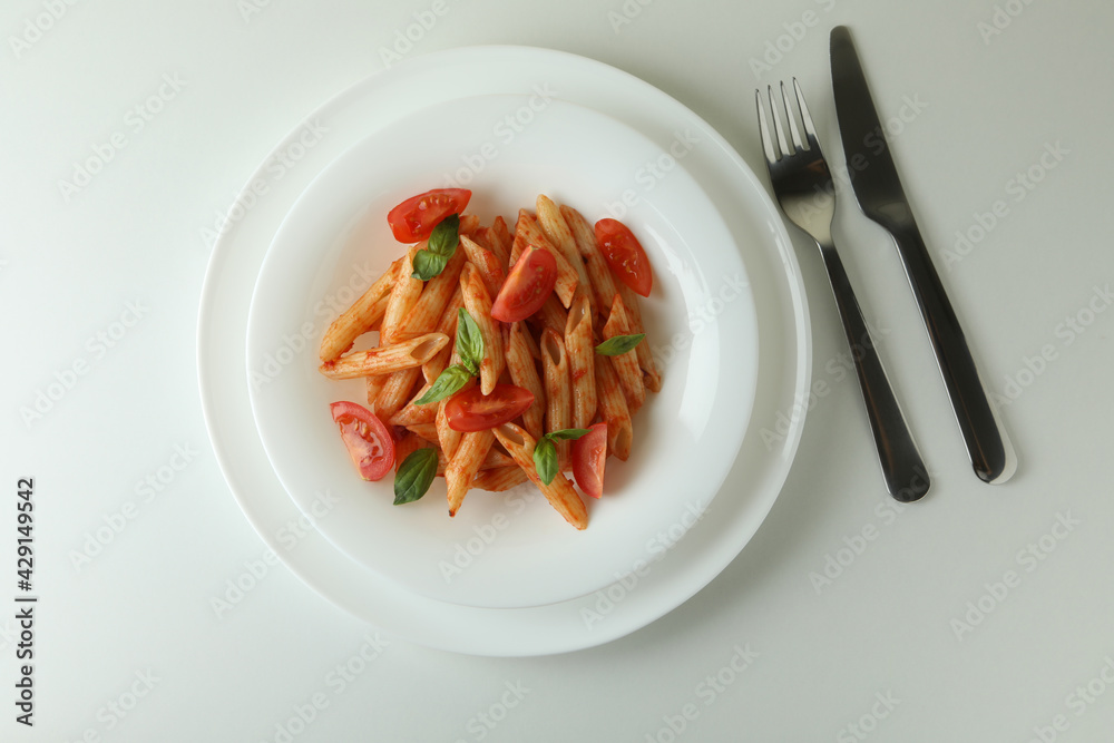Plate with pasta with tomato sauce on white background Plate with pasta with tomato sauce on white background