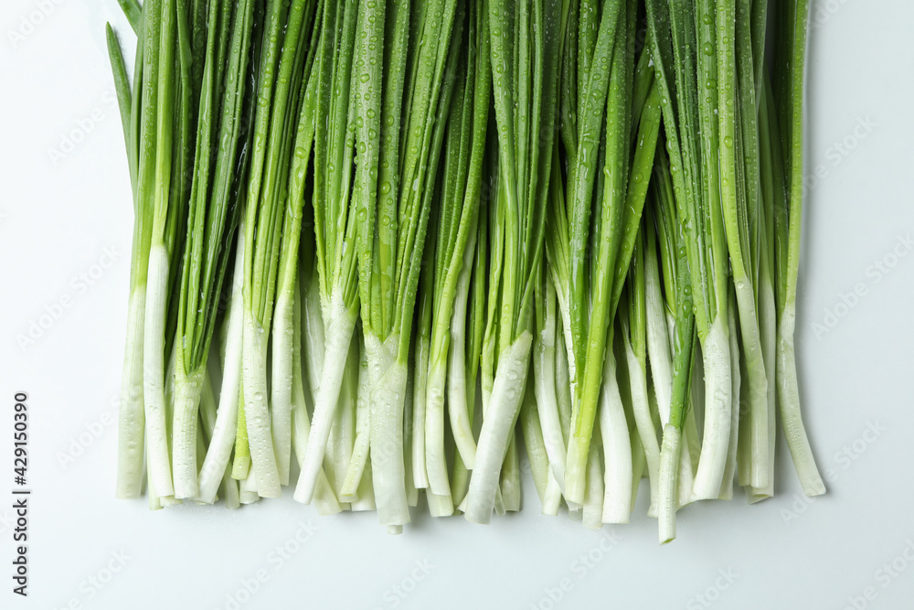 Fresh green onion with water drops on white background Fresh green onion with water drops on white background
