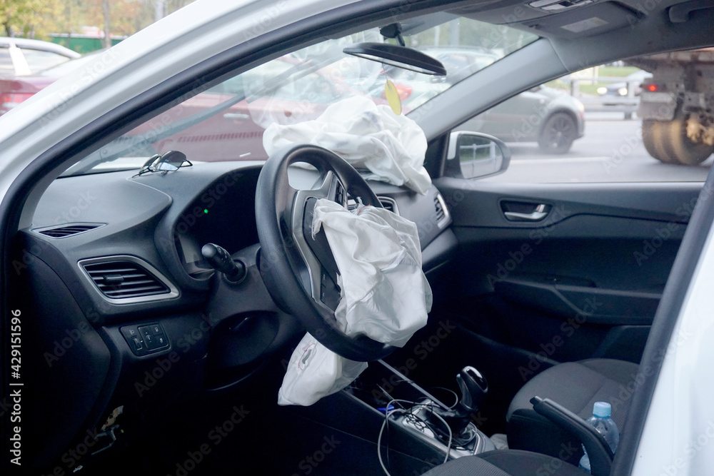 Blown airbags after tripping due to an accident. The concept of safety of the driver and passengers.