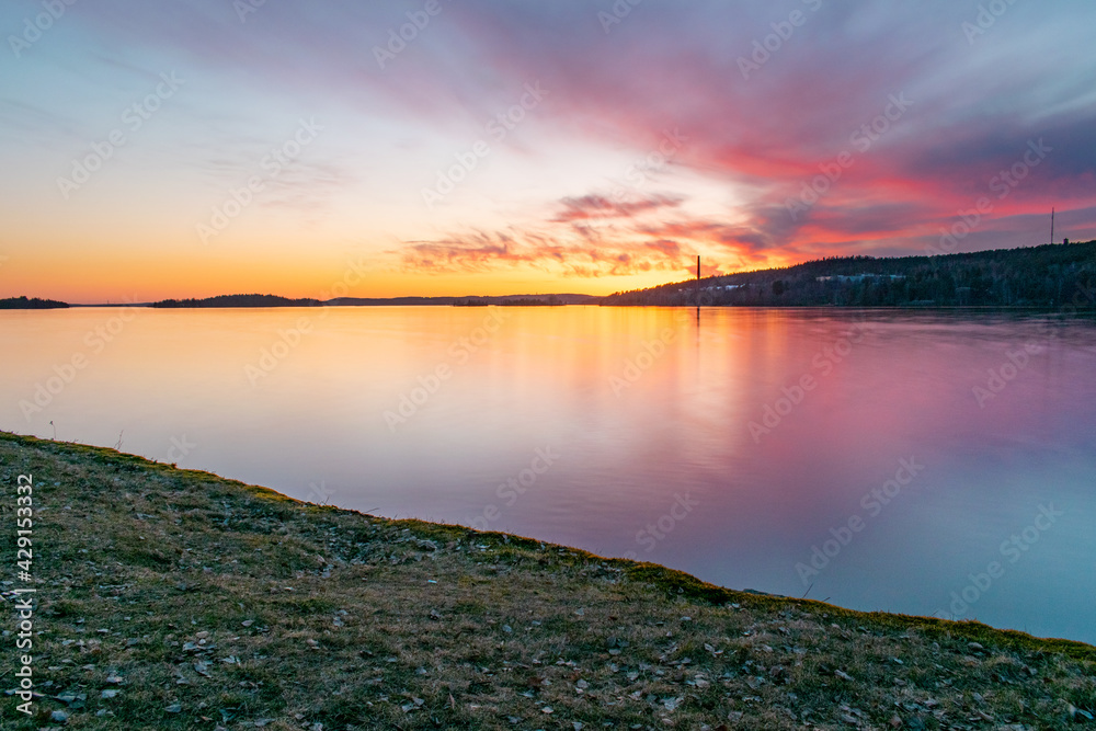Sunset over lake with colorful clouds in Tampere, Finland