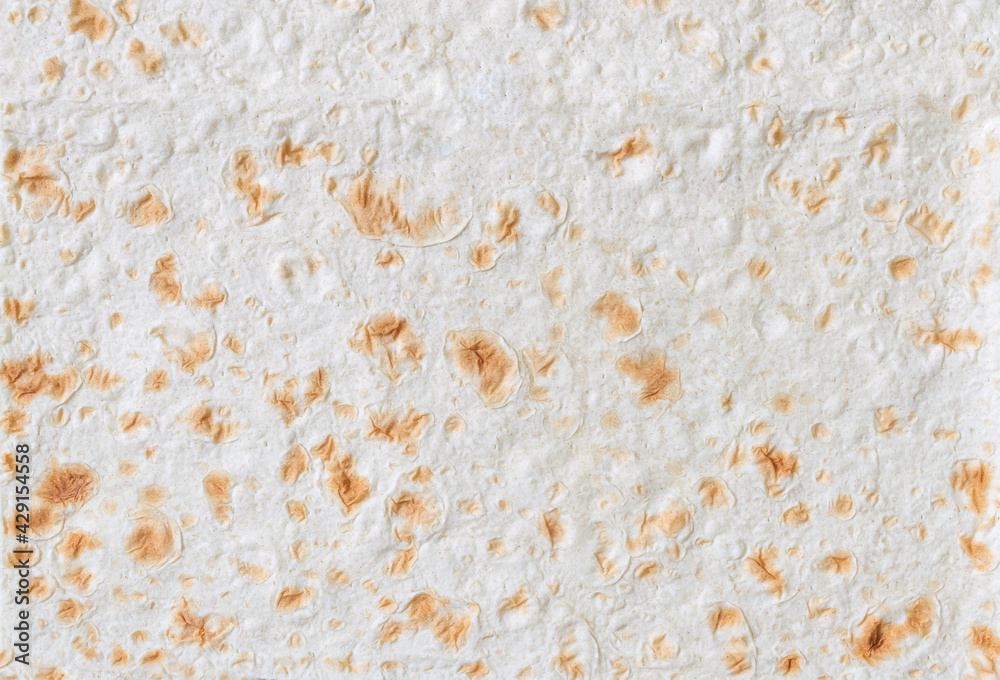 Armenian and Turkish unleavened flat bread, Close-up. Textured lavash background. Texture of thin traditional freshly baked homemade oriental bread. Armenian and Turkish unleavened flat bread, Close-up. Textured lavash background. Texture of thin traditional freshly baked homemade oriental bread.