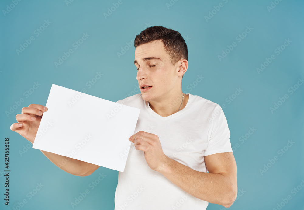 Man Holding Flyer Poster mockup blue background cropped view Man Holding Flyer Poster mockup blue background cropped view