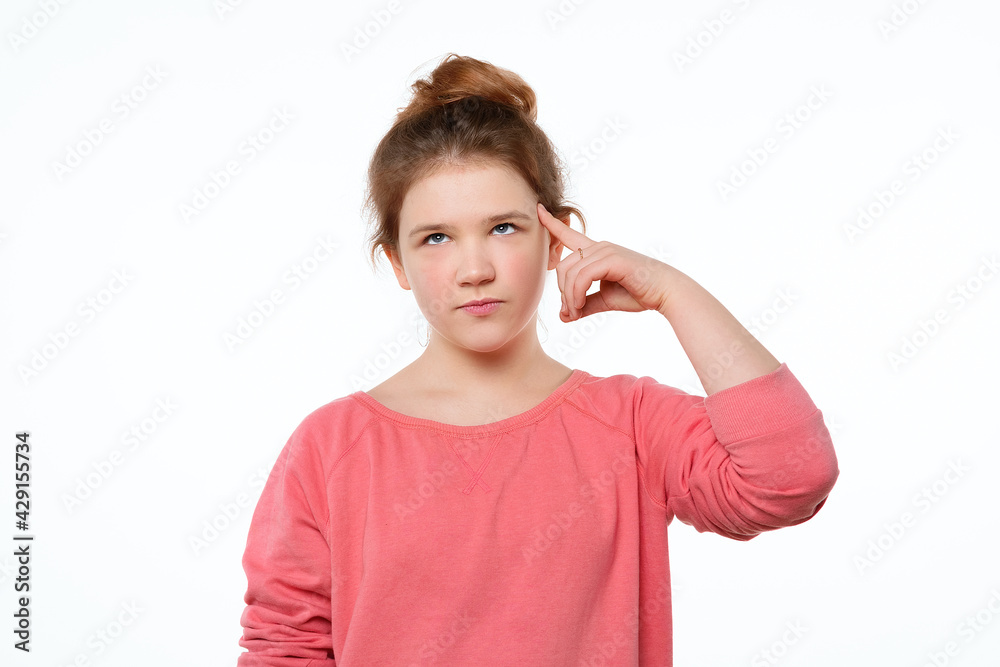 Young girl pointing to head with one finger, great idea or thought, good memory. Be smart and think Young girl pointing to head with one finger, great idea or thought, good memory. Be smart and think