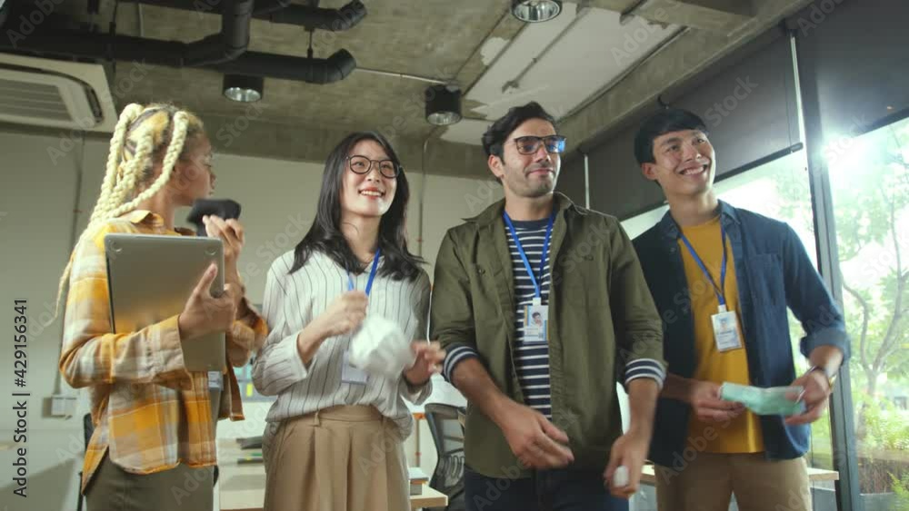 Group of creative designer takingof protective face mask together then smile with cheerful and confident after covid-19 is control office background Group of creative designer takingof protective face mask together then smile with cheerful and confident after covid-19 is control office background