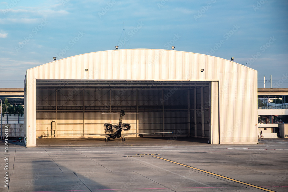 Aircrafts parking inside the hangar in airport - obrazy, fototapety, plakaty 