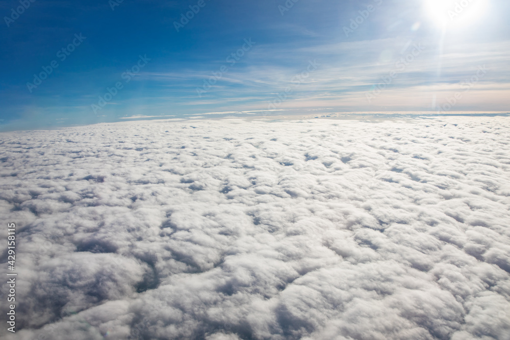 Aerial view above clouds from airplane view