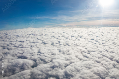 Aerial view above clouds from airplane view