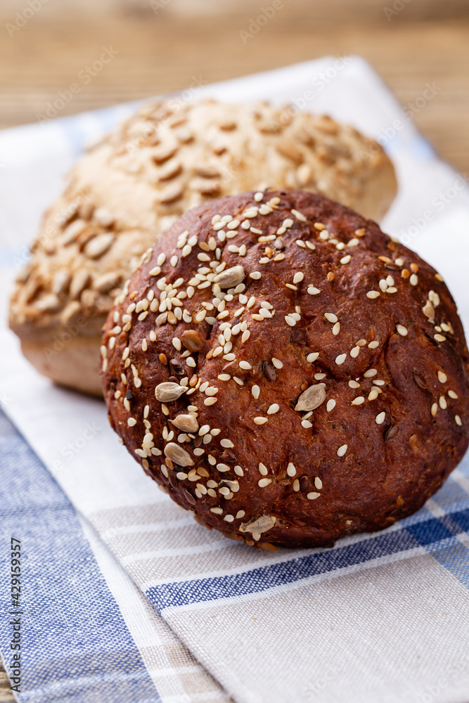Gold rustic crusty loaves of bread and buns on wooden background. Still life captured from above top view, flat lay. Gold rustic crusty loaves of bread and buns on wooden background. Still life captured from above top view, flat lay.