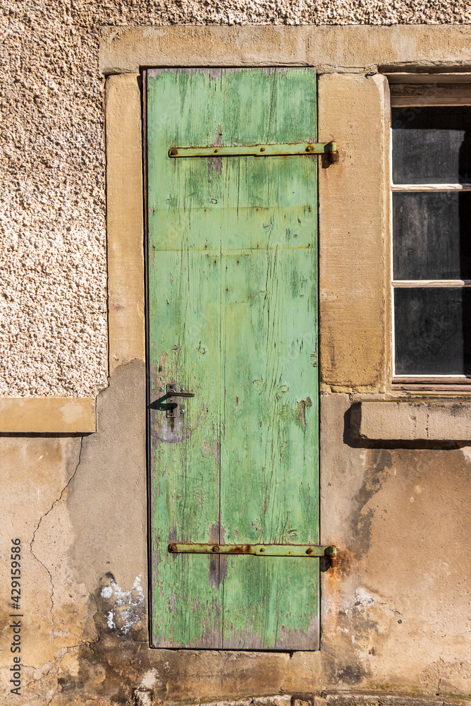 old green door in an old fabric in Switzerland old green door in an old fabric in Switzerland