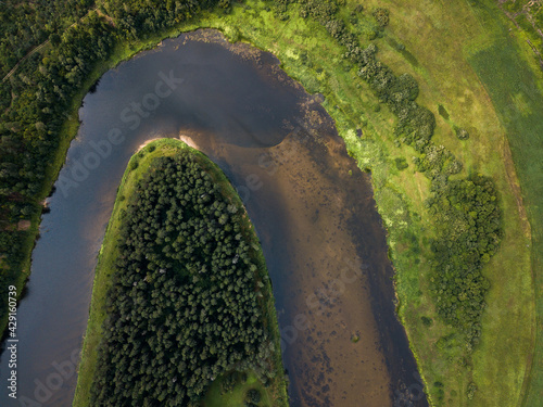 Aerial view of beautiful river bend and forests on a sunny summer day. 
