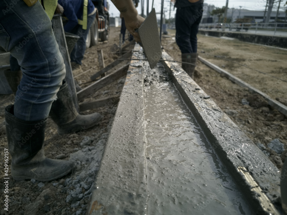 Plasterer is working on ground beams, Ground beams is constructed from concrete Plasterer is working on ground beams, Ground beams is constructed from concrete