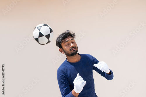Fototapeta Naklejka Na Ścianę i Meble -  Portrait of Indian goalkeeper Holding soccer ball